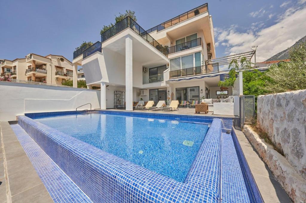 a swimming pool in front of a house at Villa Rio in Kalkan