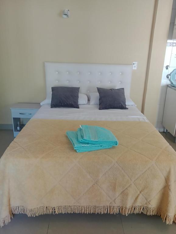 a bed with a blue towel on top of it at AlquiloenNeuquen in Neuquén