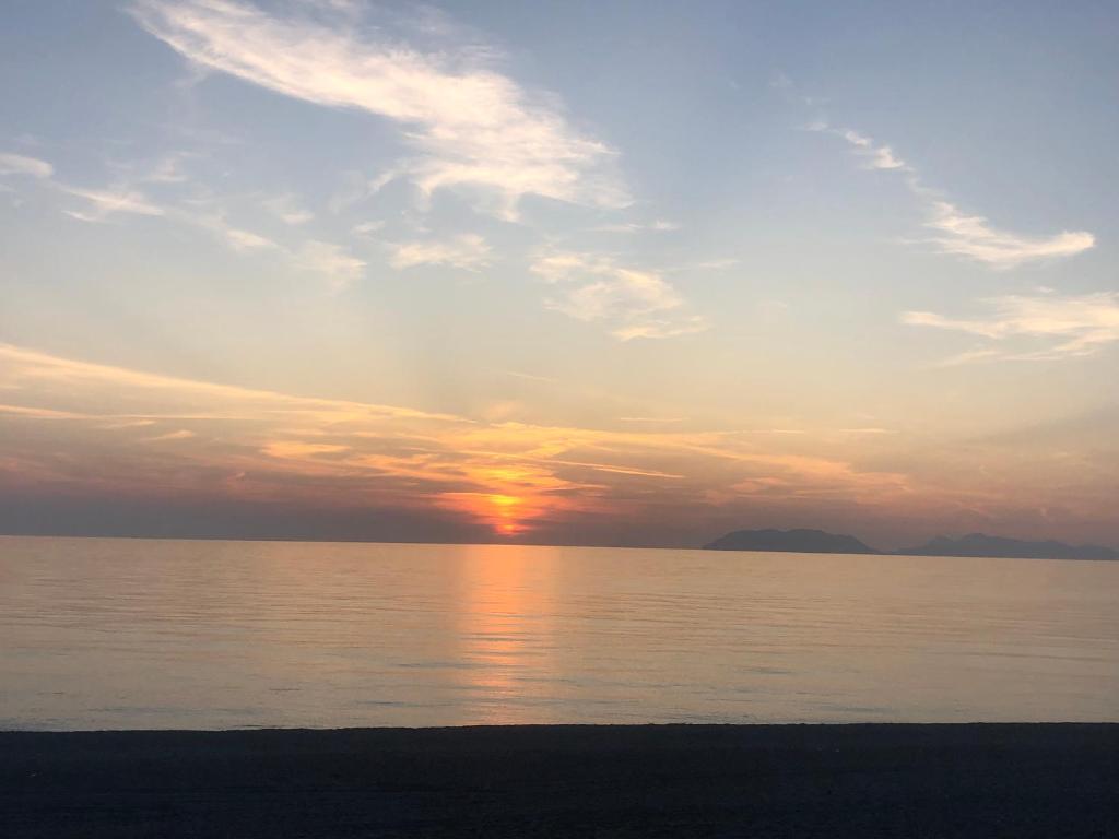 a sunset over a body of water with the ocean at Casa Glicine in Milazzo