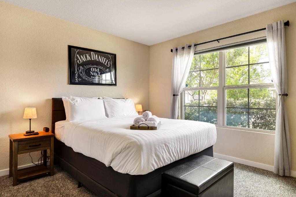 a bedroom with a bed with a teddy bear on it at Speakeasy - A Birdy Vacation Rental in San Antonio