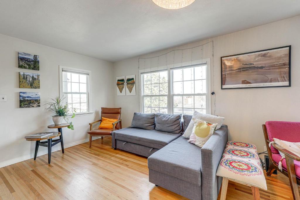 a living room with a couch and a table at Central Rapid City Home with Sunroom and Fireplace! in Rapid City