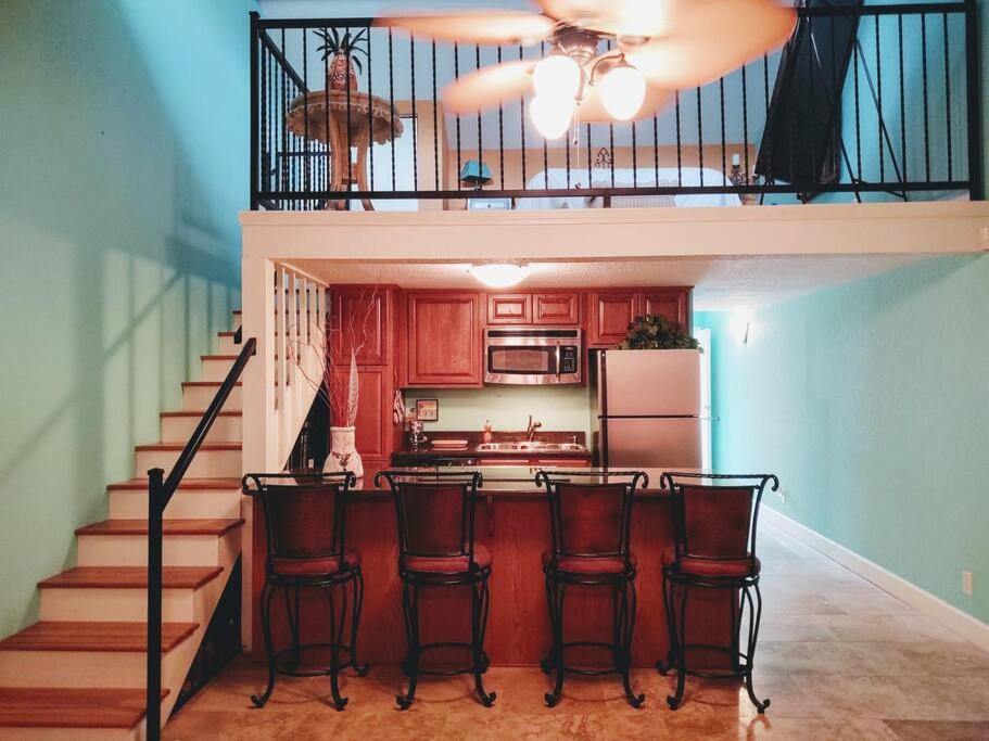 a kitchen with chairs and a kitchen with a staircase at Lakefront Casita - Perfect for couples or families in Hot Springs