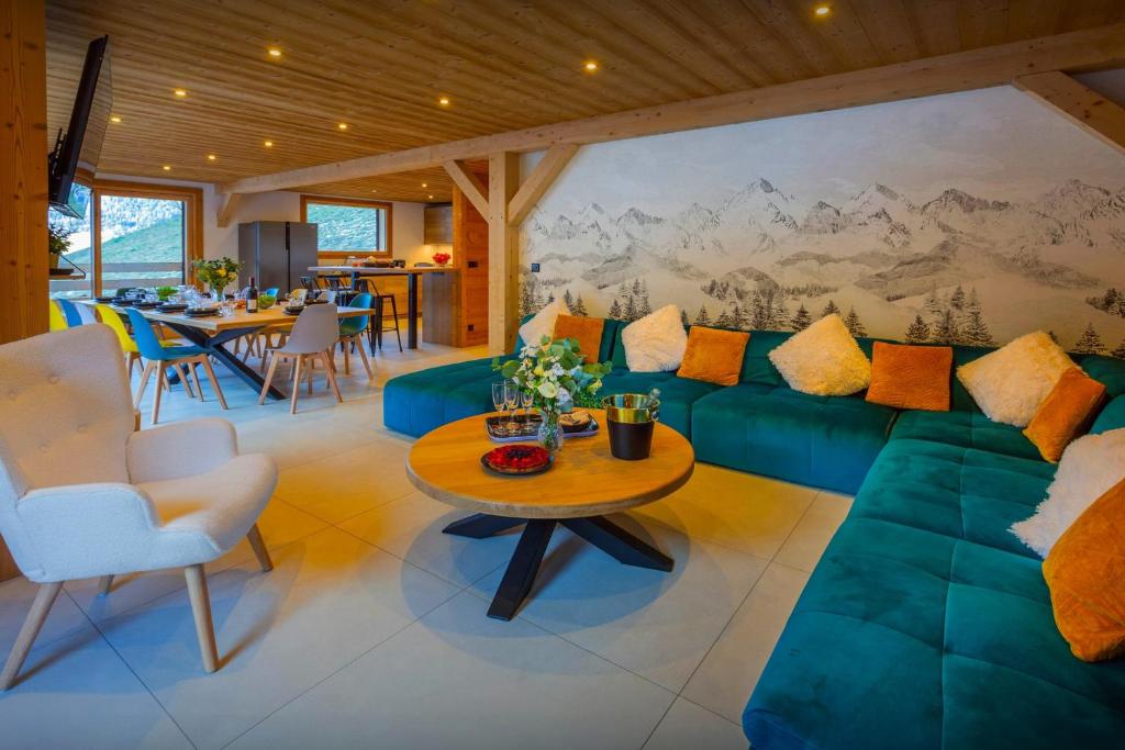 a living room with a green couch and a table at Chalet Julero - OVO Network in Le Grand-Bornand