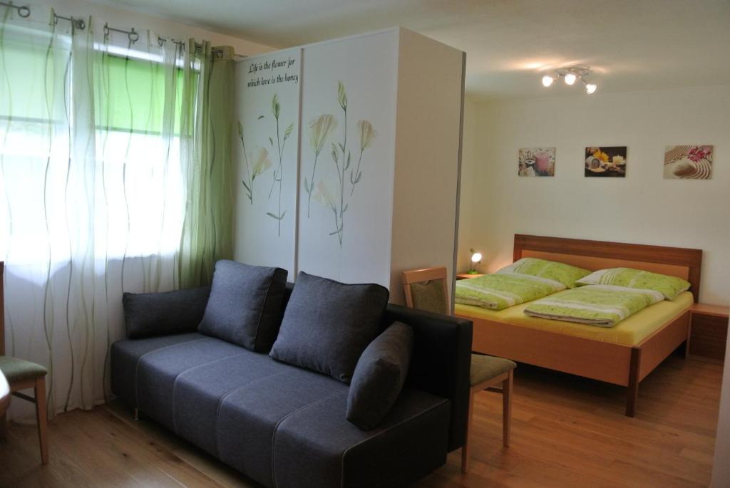 a living room with a couch and a bed at Appartement Heidi in Schladming