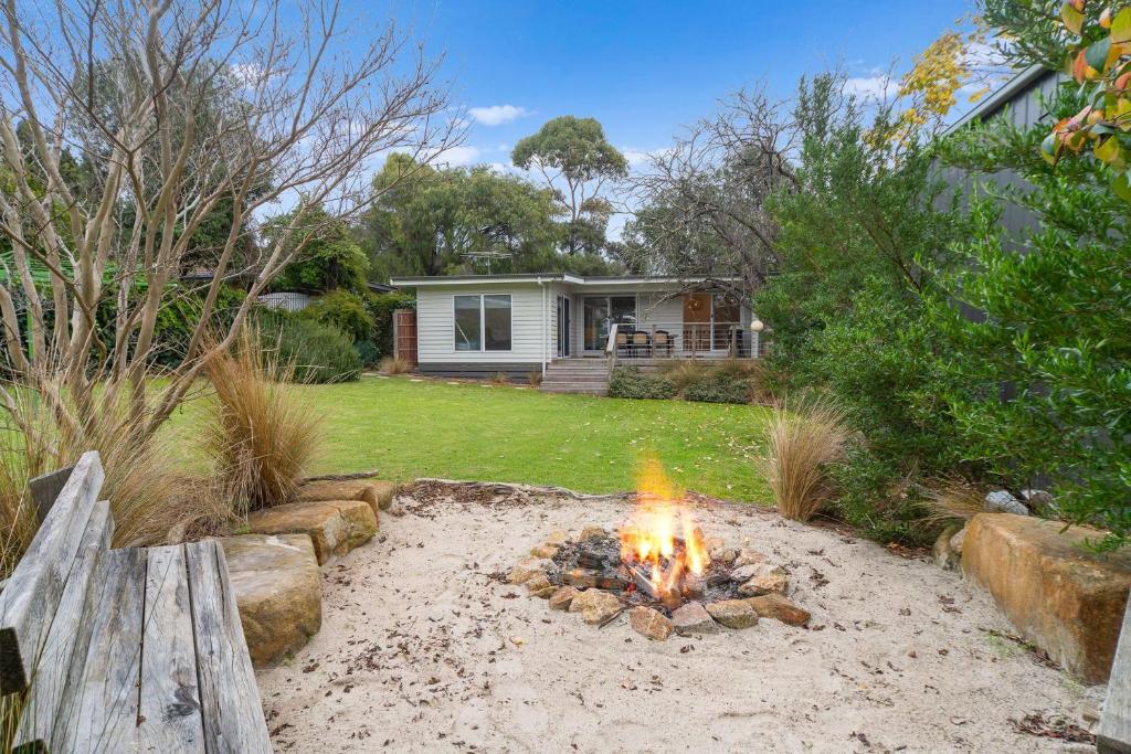 a fire pit in the backyard of a house at Secluded Seaside Hideaway in Rye