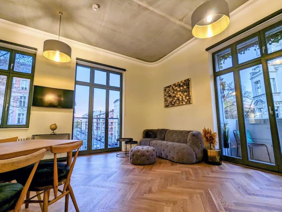 a living room with a couch and a table at Modern building with vertical garden & 2 bedrooms in Berlin