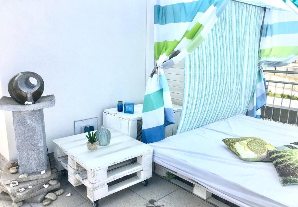 a bed and a table in a room with a window at VIP Design Apartment m. Dachterrasse in Dresden