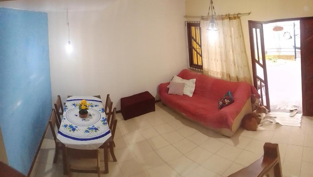 a living room with a couch and a table at Hospedaria Meu Lar in Rio das Ostras
