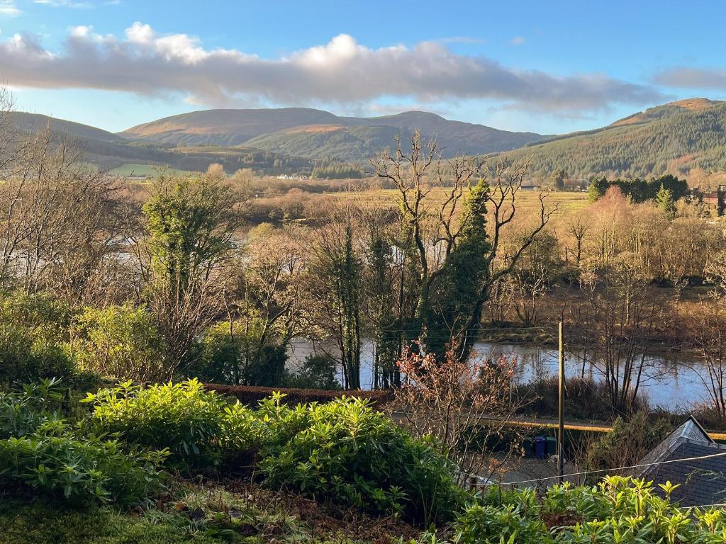 a view of a river with mountains in the background at The Holly Tree Cottage in Rashfield