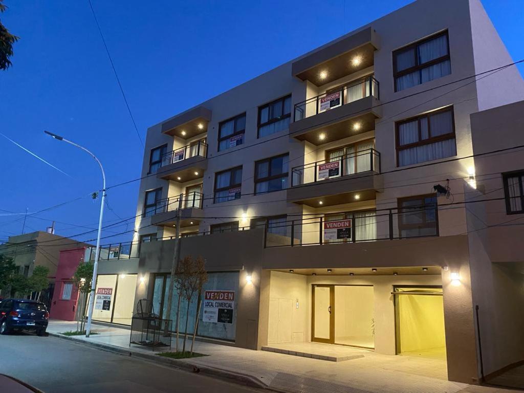 a large building on a city street at night at EN EL CENTRO DE LOBOS in Lobos