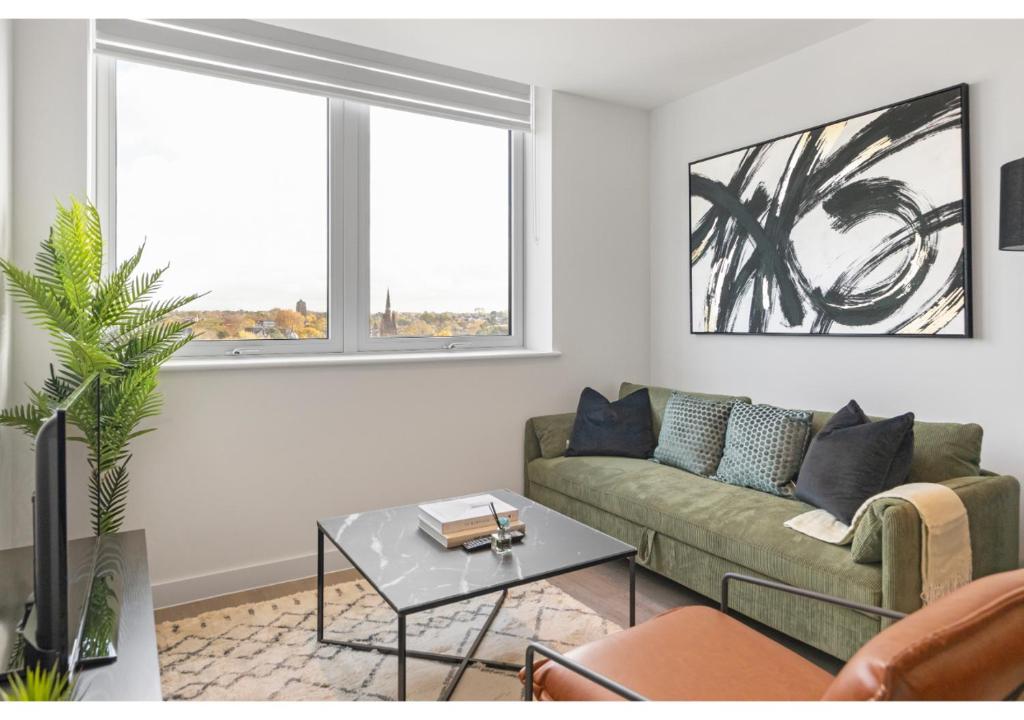 a living room with a couch and a table at Sophisticated Living: 1-BR Flat in Beckenham in Beckenham