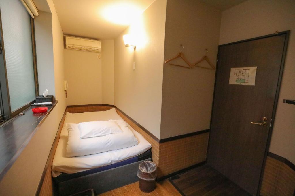 Postel nebo postele na pokoji v ubytování プチホテル　コスモス