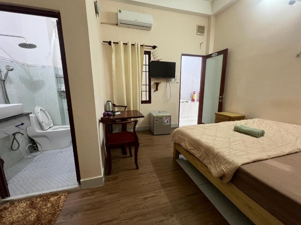 a bedroom with a bed and a bathroom with a sink at Ba Đoàn 2 Hotel in Con Dao