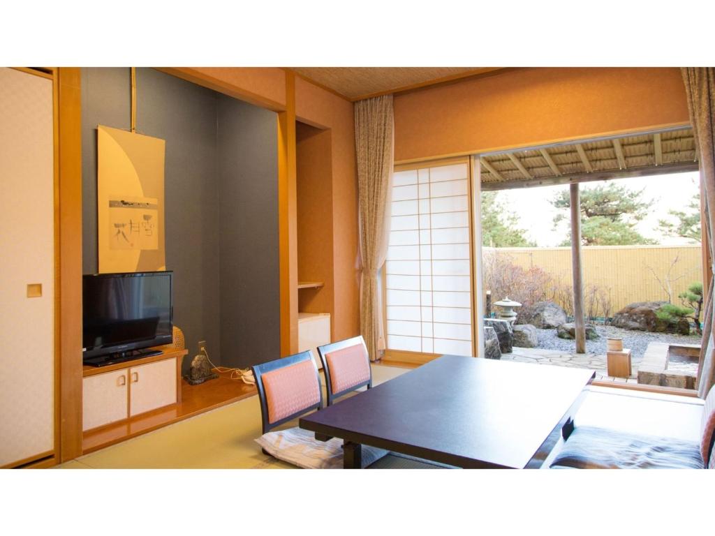 une salle à manger avec une table et une télévision dans l'établissement Hotel Keipu - Vacation STAY 11124v, à Hakodate