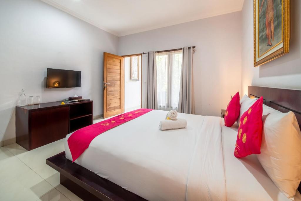 Tempat tidur dalam kamar di The Kutaya