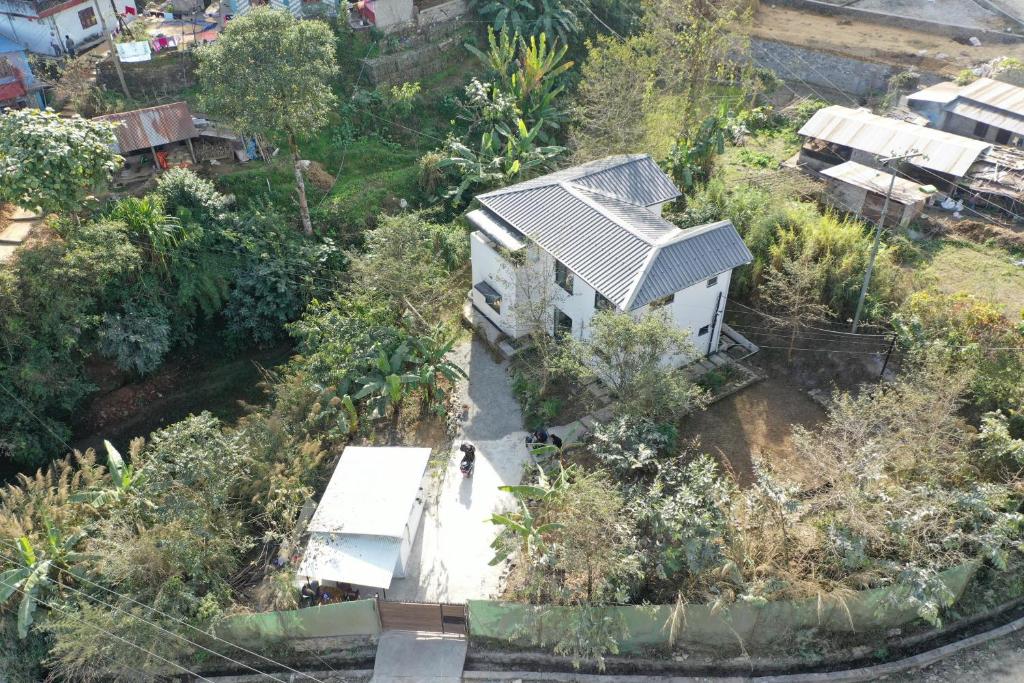 an overhead view of a house with a woman standing outside at Bali Villa Pokhara in Pokhara