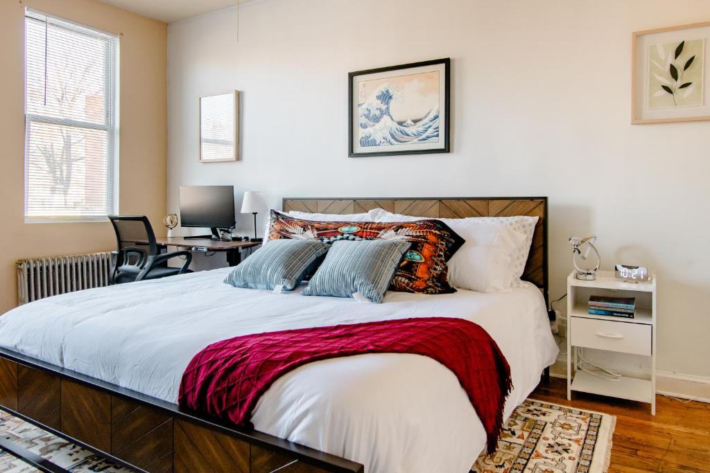a bedroom with a large bed and a desk at 2 Bedrooms at the heart of the City! Full Comfort! in Washington, D.C.