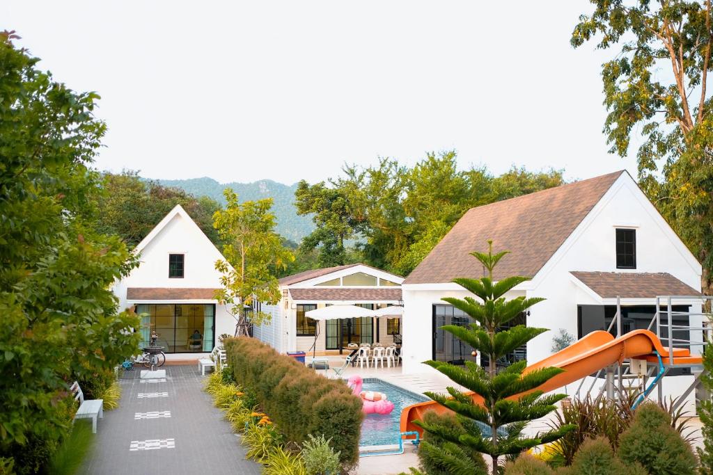 a house with a pool and a slide at Chamonte Pool Villa Khao Yai in Ban Muak Lek Nai