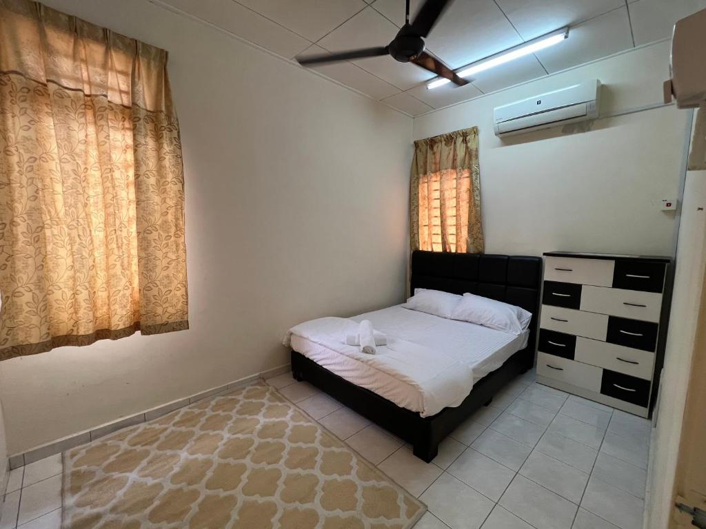a small bedroom with a bed and a window at Al-Ahsan Homestay in Pasir Gudang