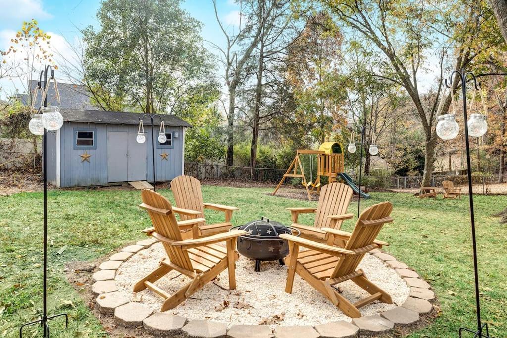 a group of chairs and a fire pit in a yard at Chic, modern retreat, kids&dog friendly, DT Matthews in Charlotte