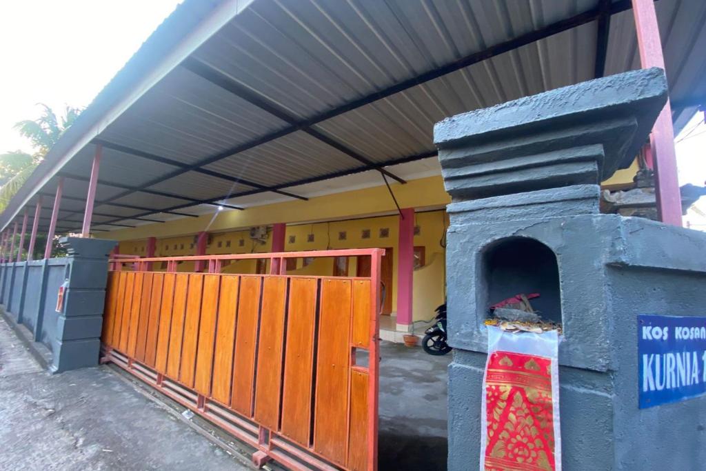 a building with a pizza oven in front of it at OYO Life 93259 Kos Kurnia in Tanjung