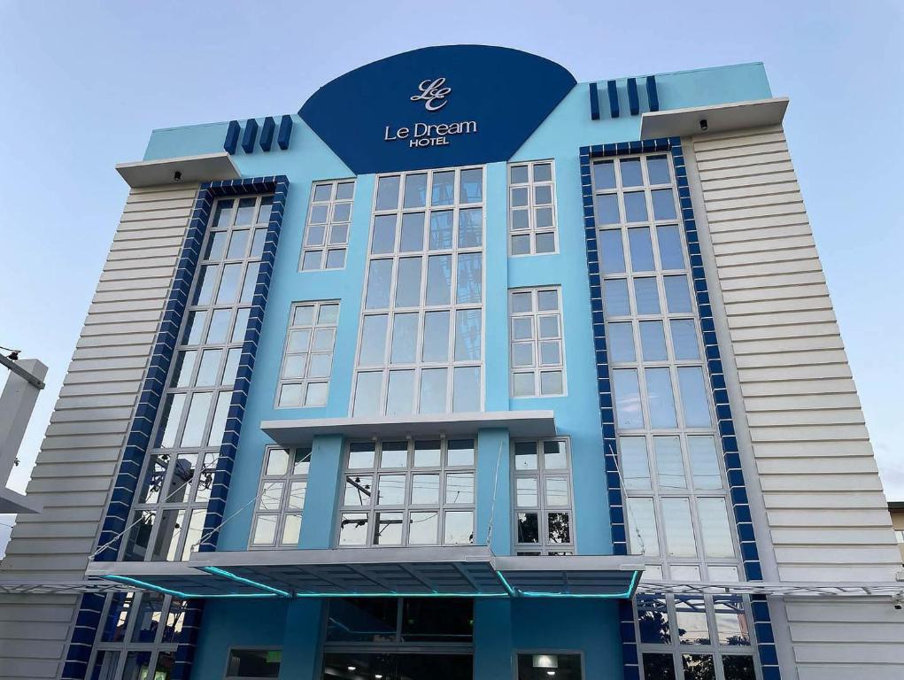 a large blue building with a sign on it at Le Dream Hotel in Anomang Mayor