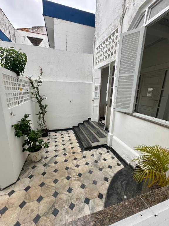 a house with a tiled floor in front of a door at Casa de Maria Marta in Ilhéus