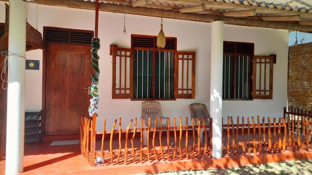 a house with a fence and a door and windows at Ranmitha Villa Weligama in Weligama