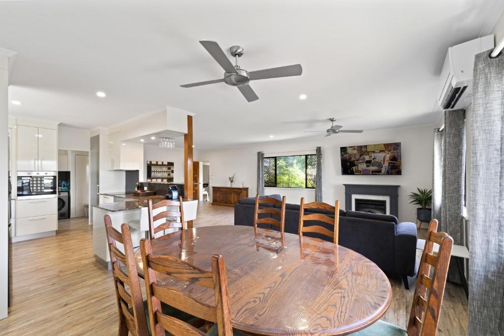 a dining room and kitchen with a table and chairs at Highview Atherton in Atherton