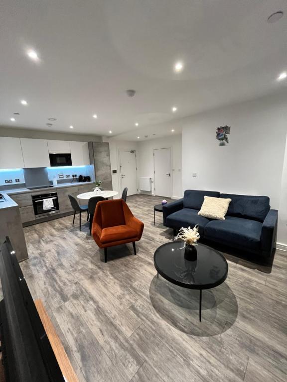a living room with a couch and a table at One bedroom Apartment in Barking