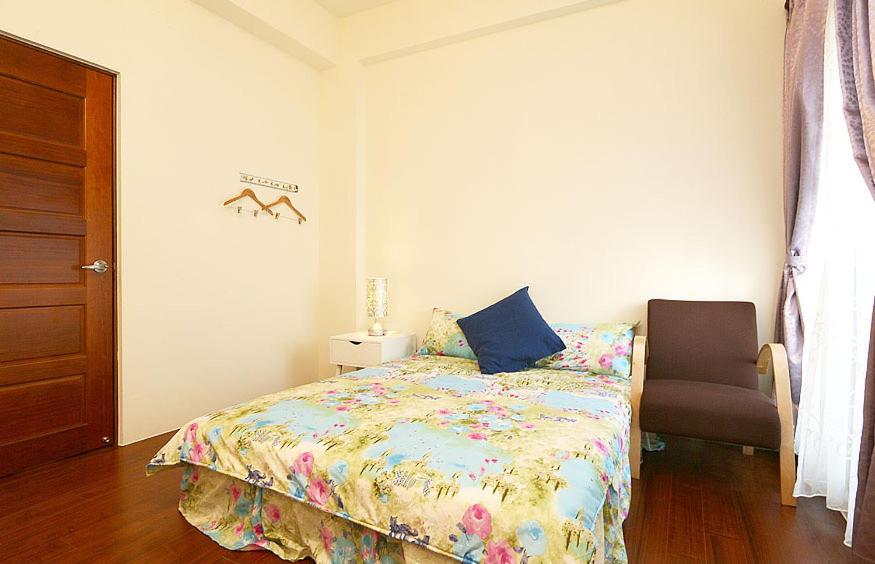 Postel nebo postele na pokoji v ubytování Yilan Greenbird of Happiness B&B