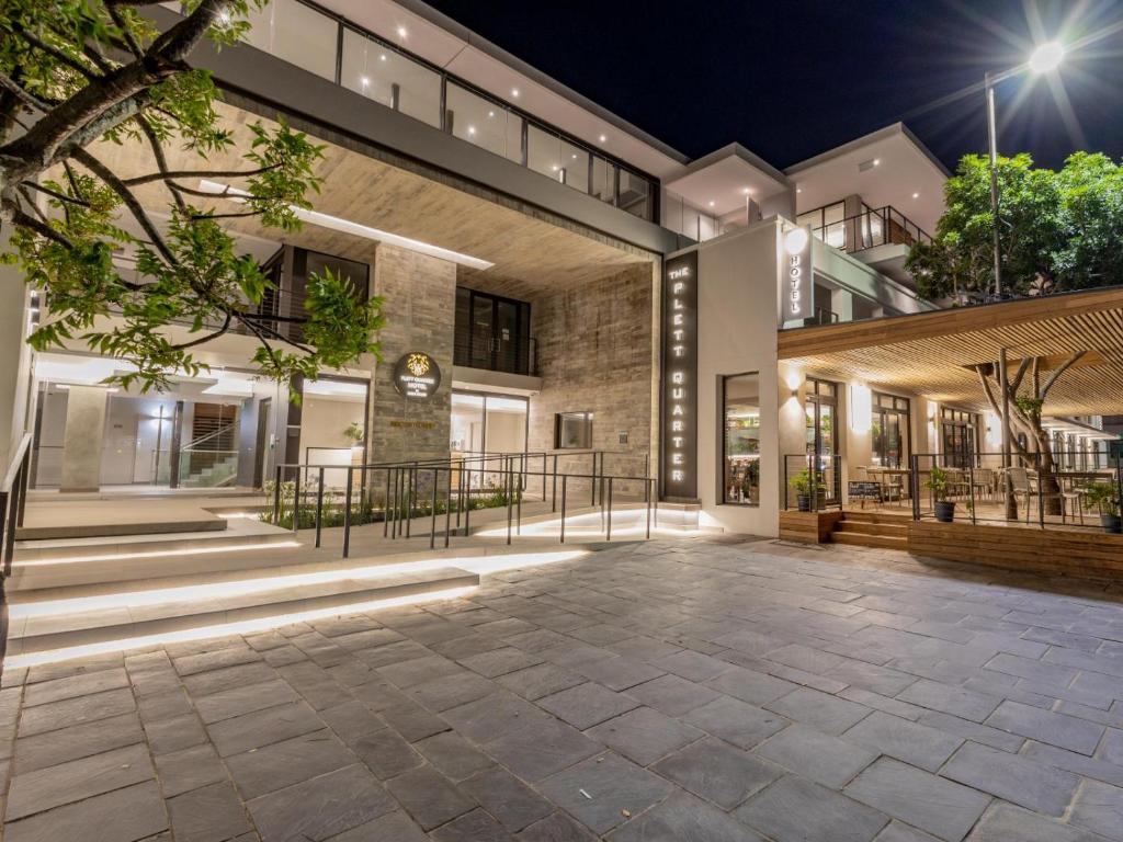 an empty courtyard of a building at night at Plett Quarter Apartments in Plettenberg Bay