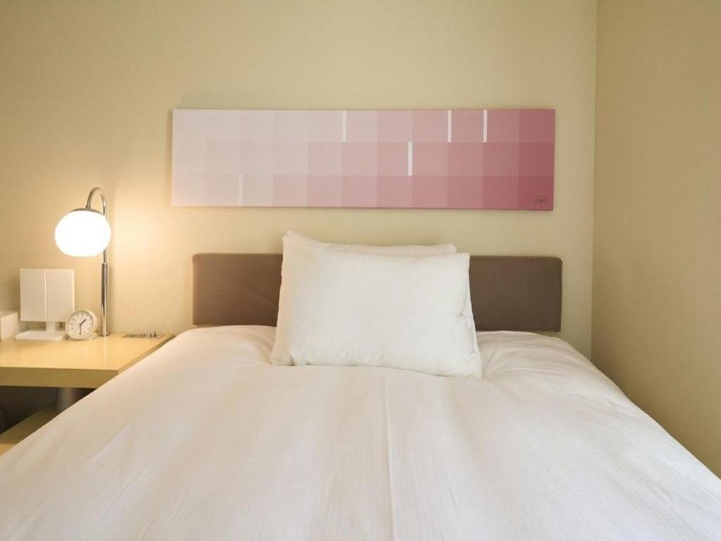 Postel nebo postele na pokoji v ubytování Hotel Resol Ikebukuro