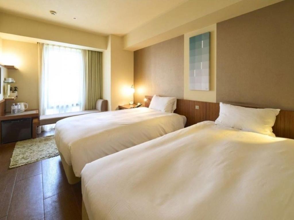 Postel nebo postele na pokoji v ubytování Hotel Resol Ikebukuro