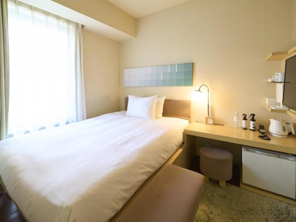 Postel nebo postele na pokoji v ubytování Hotel Resol Ikebukuro