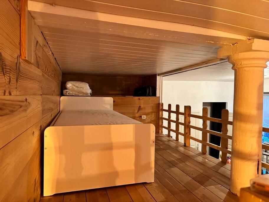 a bedroom with a bed on a wooden floor at Appart. spacieux et lumineux 4 pers. in Morez