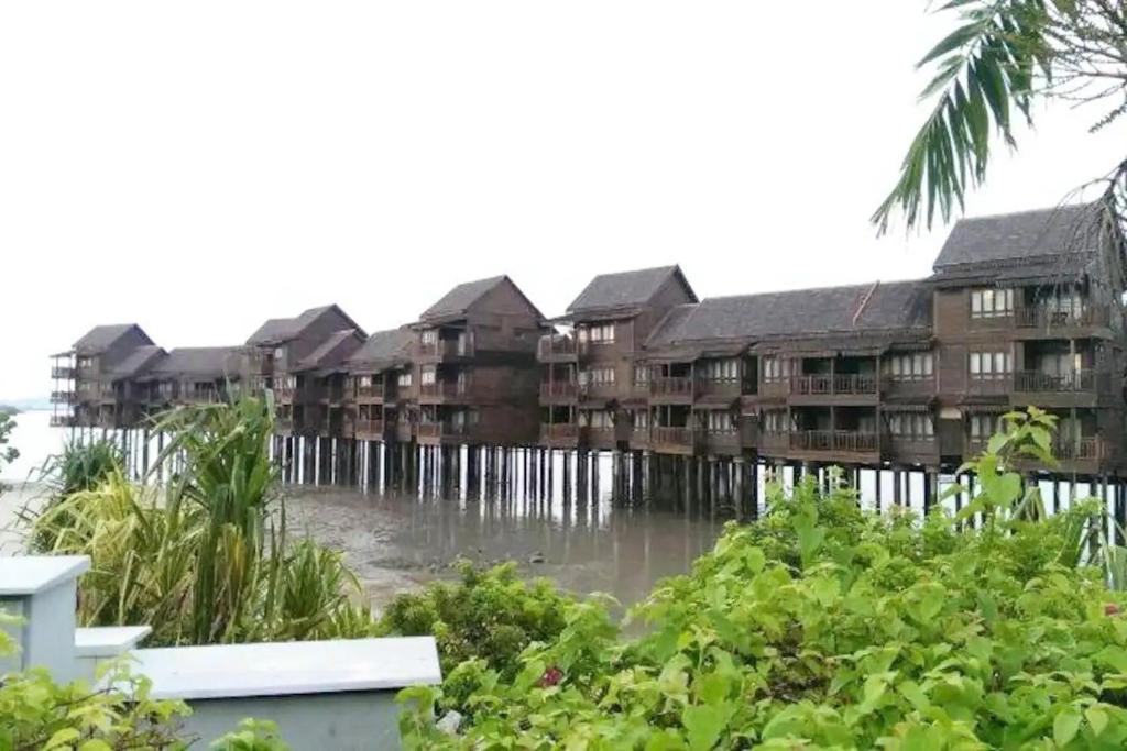 a group of apartment buildings on the water at Renovated 2 Bedroom Seavilla for 6pax in Pantai Cenang