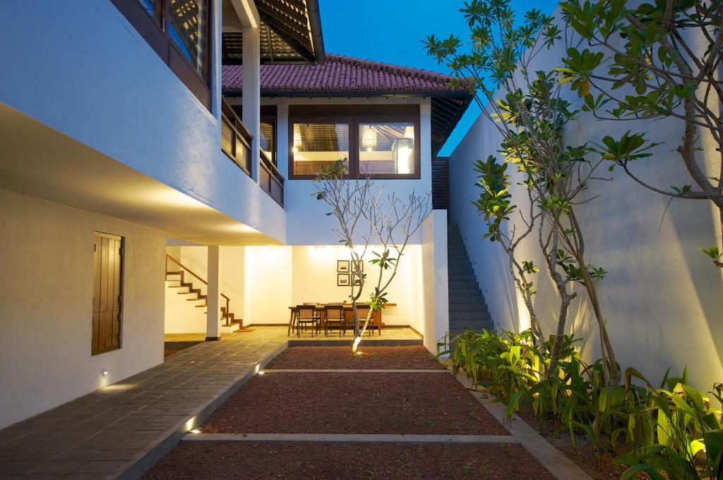 a house with a pathway leading to the front yard at Jetwing Thalahena Villas in Negombo