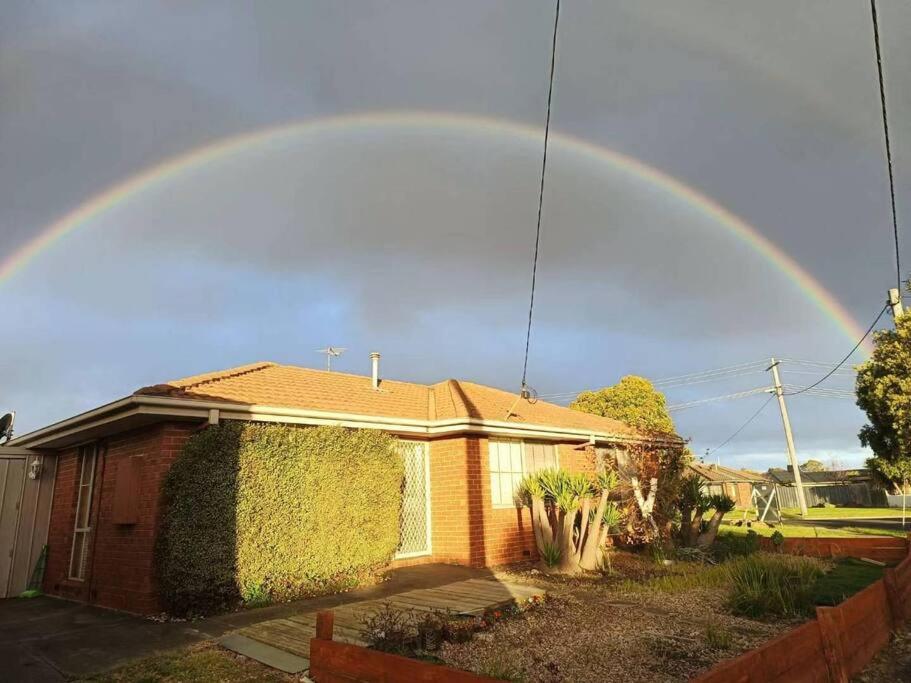 a rainbow in the sky over a house at Y&Y Holiday House in Craigieburn