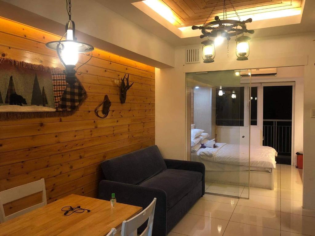 a living room with a couch and a bedroom at Wind Suites in Tagaytay