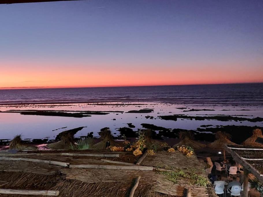 a view of the ocean at sunset at Asilah beach Apartment seaview in Asilah