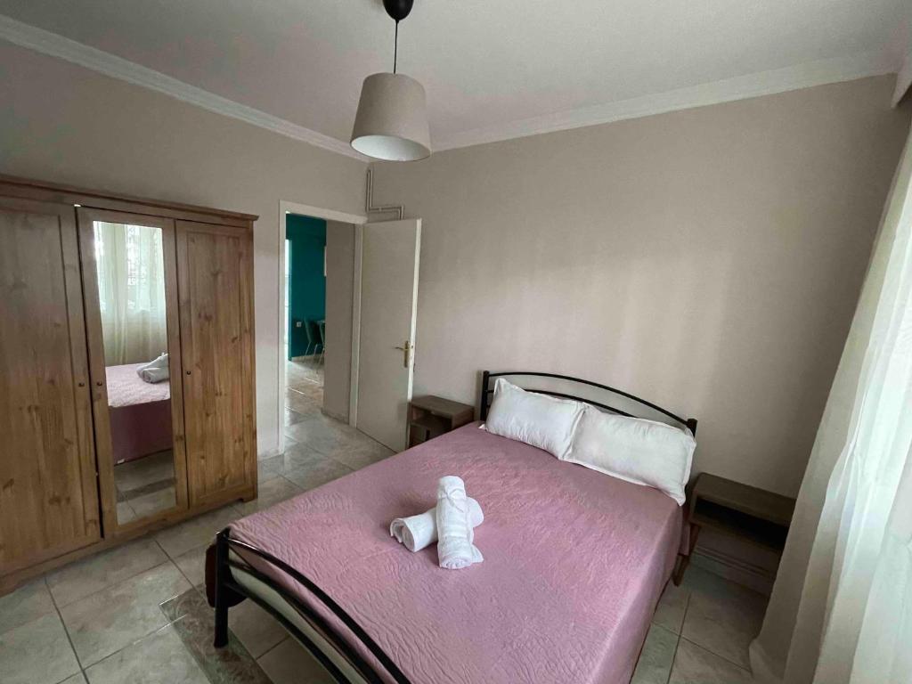 a bedroom with a bed with a teddy bear on it at Marina Apartmets in Thessaloniki