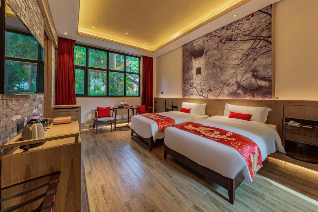 Postel nebo postele na pokoji v ubytování Shenzhen OCT Gankeng Ancient Town Phoenix Hakka Hotel
