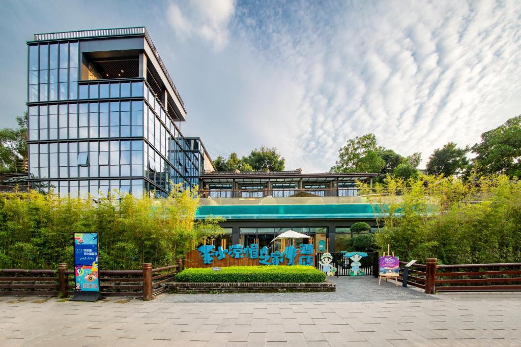 a building with a garden in front of it at Little Hakka Hotel in Shenzhen