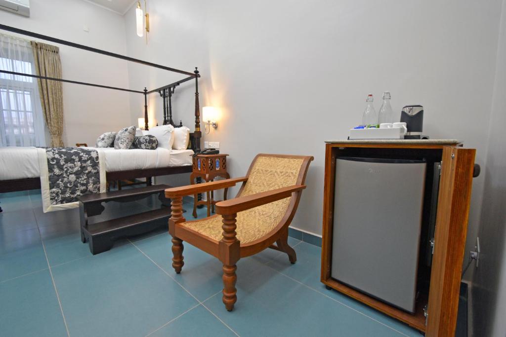 Postel nebo postele na pokoji v ubytování Le Colonial Suites
