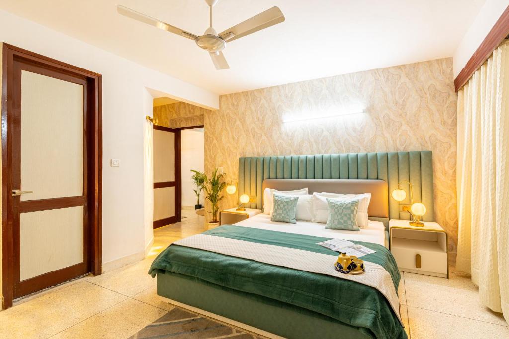 a bedroom with a bed and a ceiling fan at Homlee-Excellency 4BHK Apt in South Delhi in New Delhi
