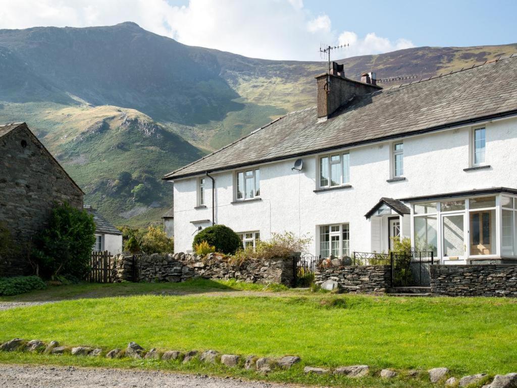 a white house with mountains in the background at 3 Bed in Grange in Borrowdale SZ262 in Grange