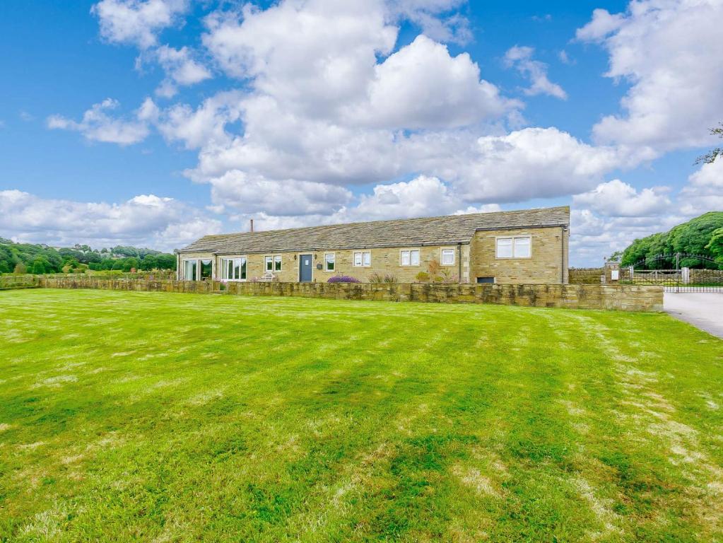 an old brick house with a large grass field at 3 Bed in Denby Dale 88924 in Denby Dale