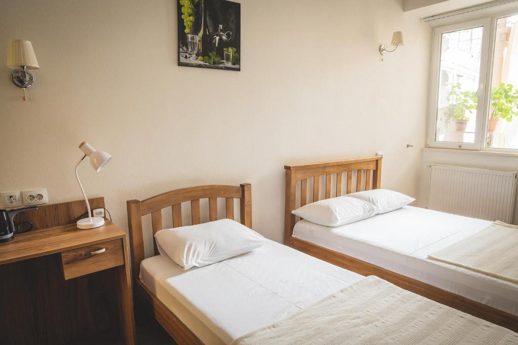 Postel nebo postele na pokoji v ubytování HH Hotel