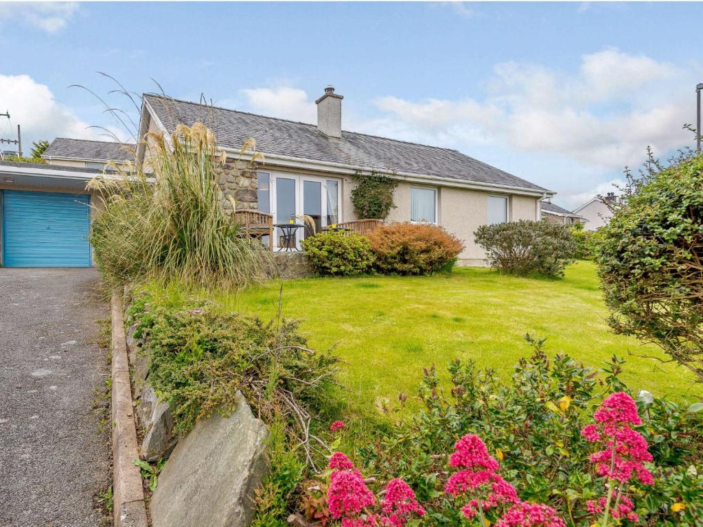 a house with a garden in front of it at 3 Bed in Harlech 42153 in Harlech